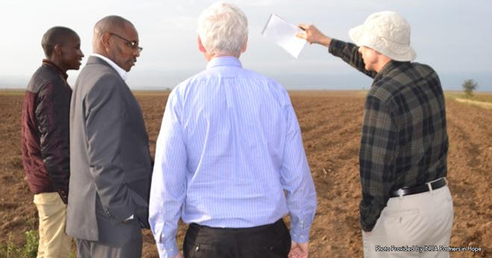 The displayed photo was given and taken by a missioner who was inspecting the Panua farm. On a beautiful day out on the farm, 4 gentleman are discussing the potential of the Panua farm. The Panua farm is a 5-acre farm that is near Naivasha and it is a part of the agriculture training program. In the training program, staff members teach those in Naivasha the value of a balanced and nutritional diet, modern techniques to prep soil, plant seeds, maintain plants and to harvest and store crops. On the right side of the picture, you can see part of the actual farm. In this part of the farm, you can see the training given to the people in affect. Here the field is was plowed to prep the soil to plant the seeds. Furthermore in this particular farm, the residents are prepping the soil to plant both beans and corn (maze). The harvest of beans in the Panua farm in its second year was five times as great compared to its first year. Additionally, these two crops are a very important diet here in Kenya. The main goal of this farm is to be the pilot for the rest of the farms that may be developed in the near future. From this farm, the youth in the Naivasha market will be able to develop skills on how to sell their harvest and create a self-sustaining business.