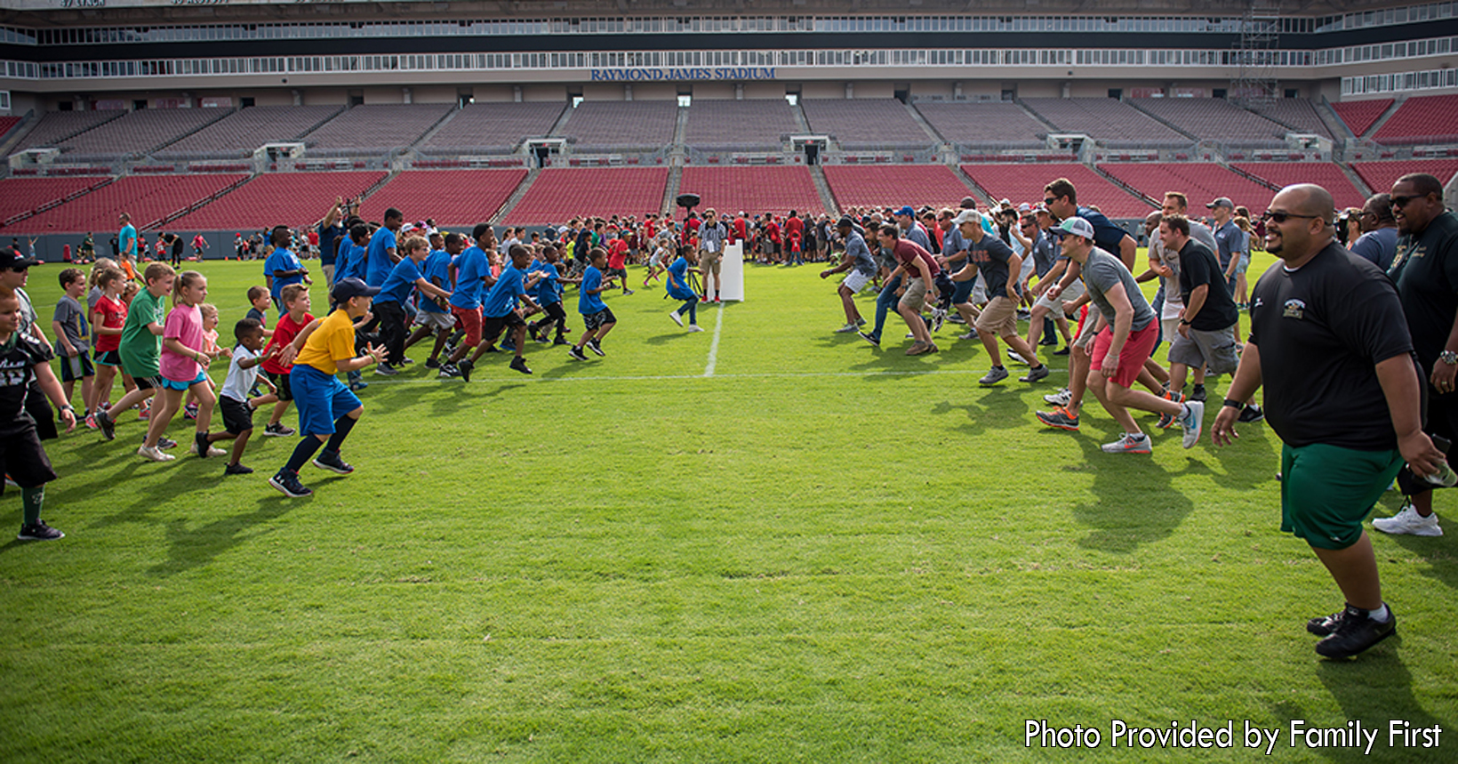 Fathers and their children participate in a wide range of activities during All Pro Dad. Here in this NFL facility, the dads along with their children are enjoying themselves while the get to know each other better.