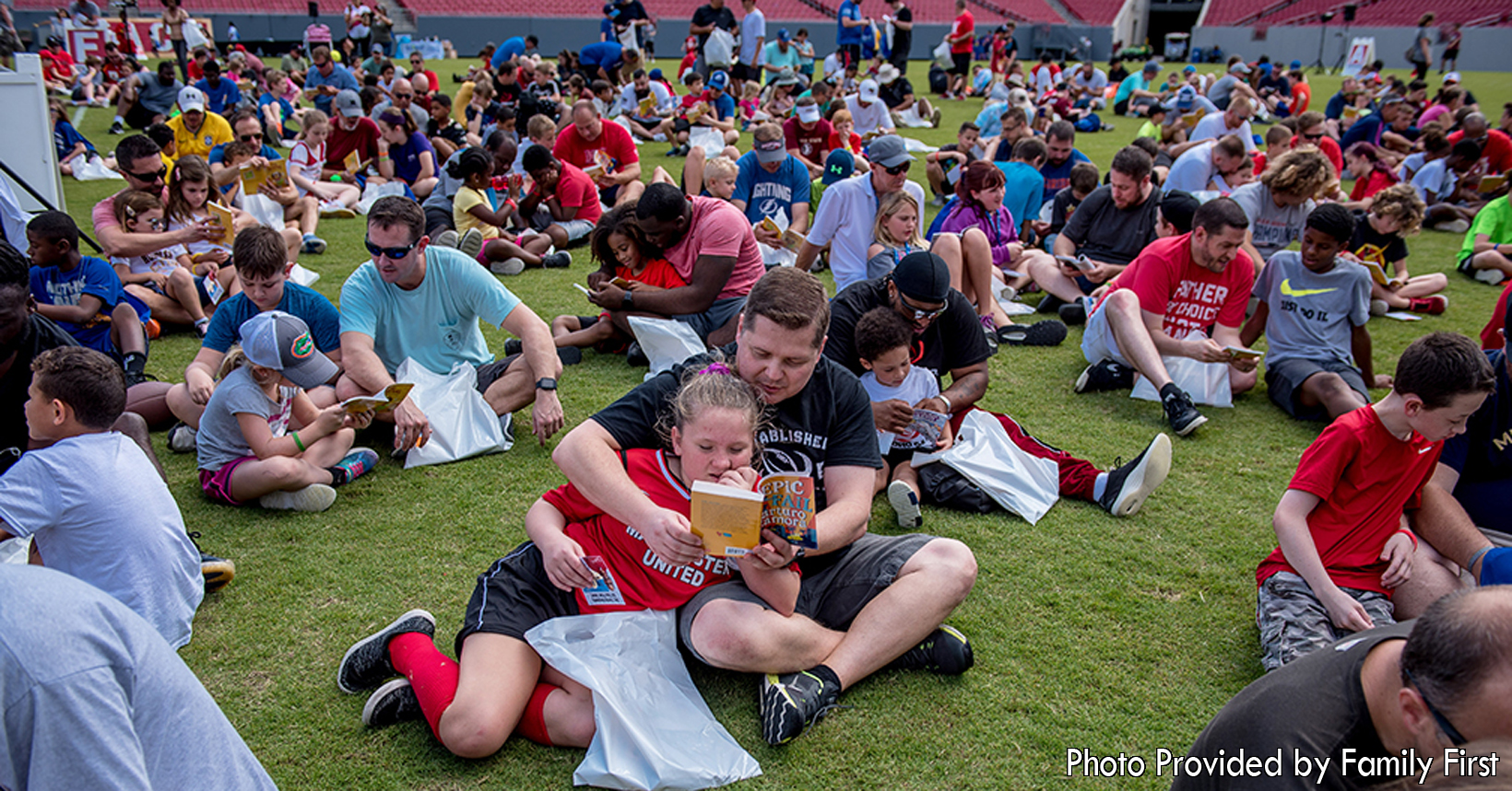 After enjoying so outdoor activities, dads with their kids sit down to enjoy some reading.  Each of the groups get their very own book to enjoy quietly.