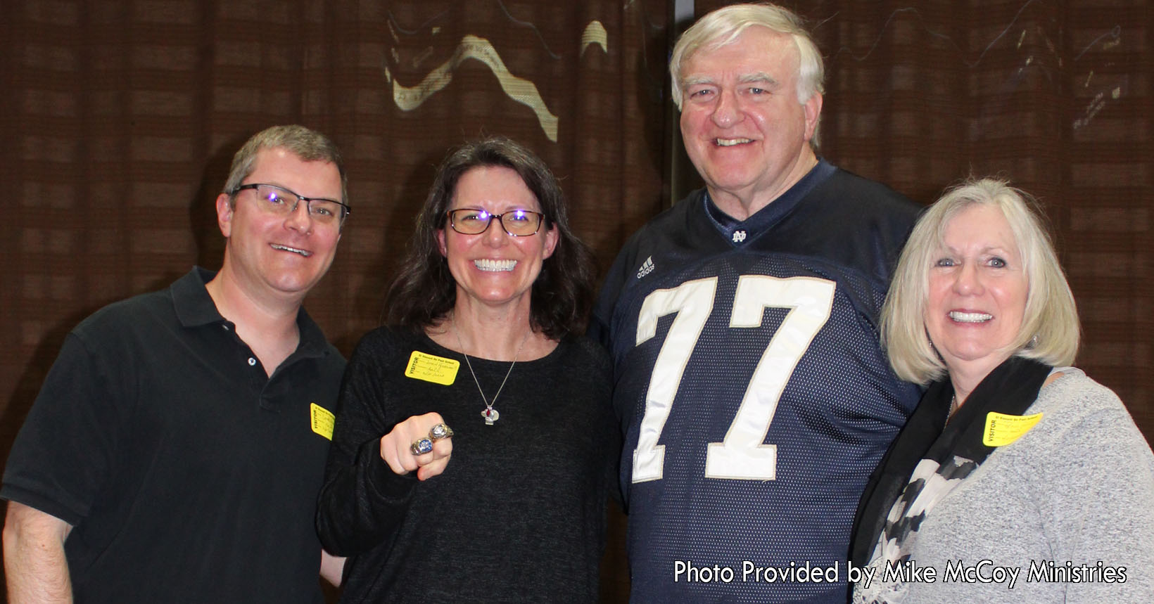 Mike McCoy (wearing jersey #77) graduated from the University of Notre Dame where he played football. After graduation he played in the NFL for the Raiders, Giants, and the Packers. After his career, he decided to help the young generation with the things he had learned.