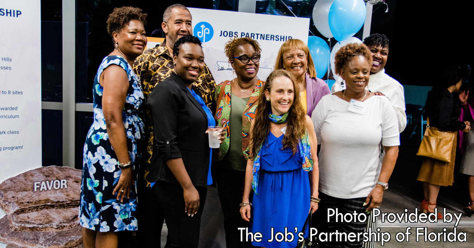 The man and women gathered here are smiling and celebrating with one another. They are volunteers from the Washington Shores Church of Christ. Their new training site for LifeWorks opened in February 2020.