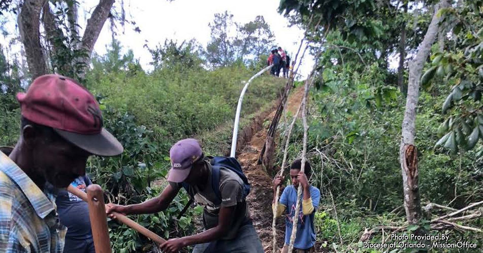 It is the job of some of the men to create a path for the pipeline. Using shovels, they are digging a trail to lay down the pipe.