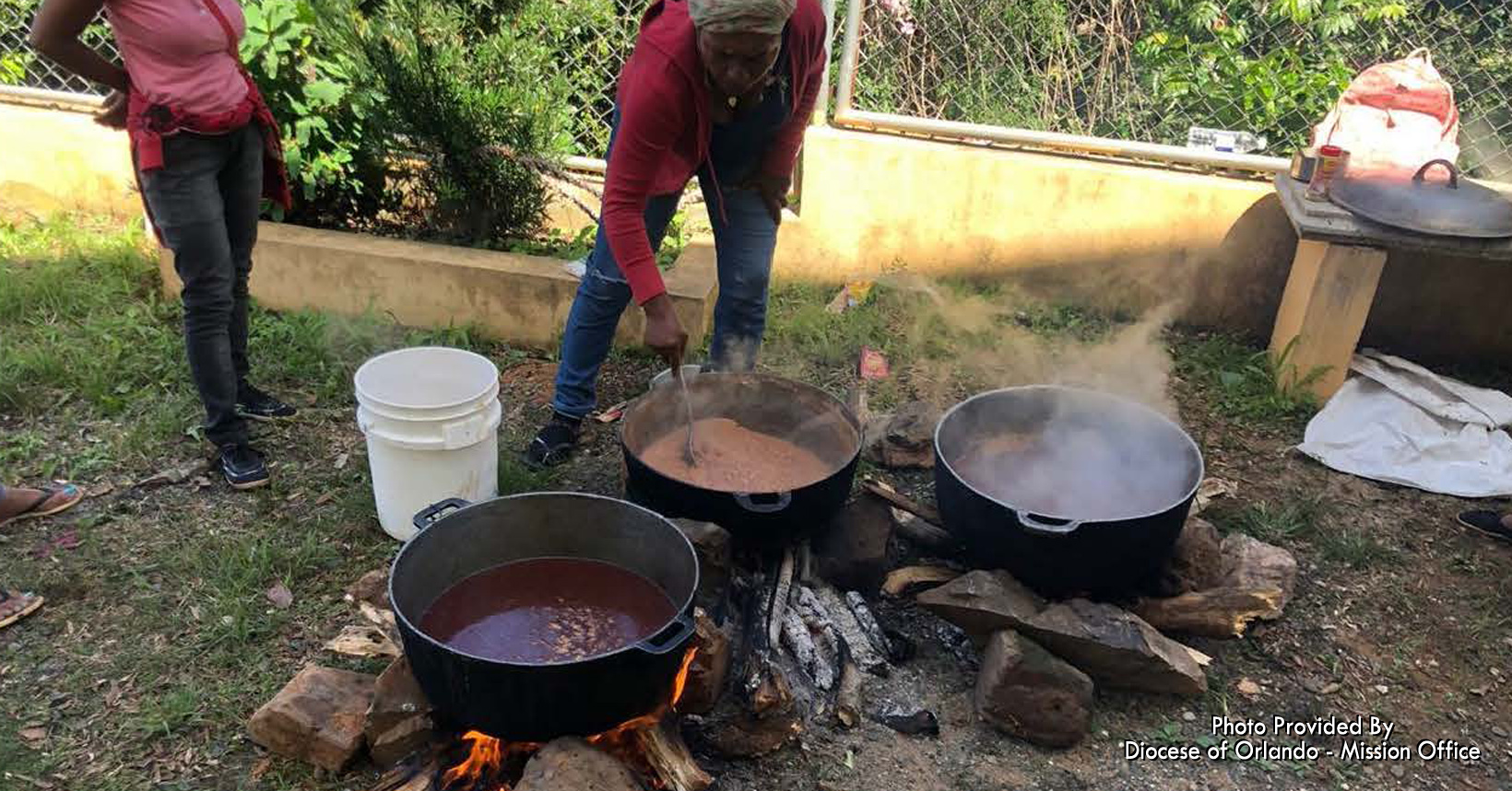 This group of individuals is preparing food for everyone first thing in the morning.