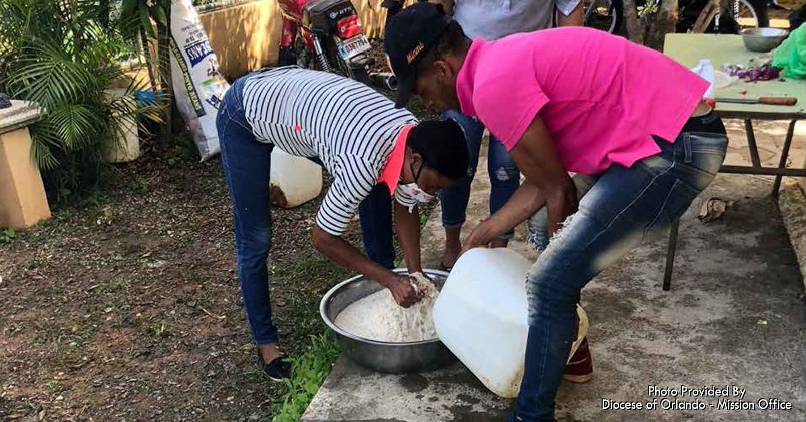 Everyone is contributing to building the pipeline in the mountains. This group is helping everyone by cooking and serving lunch.