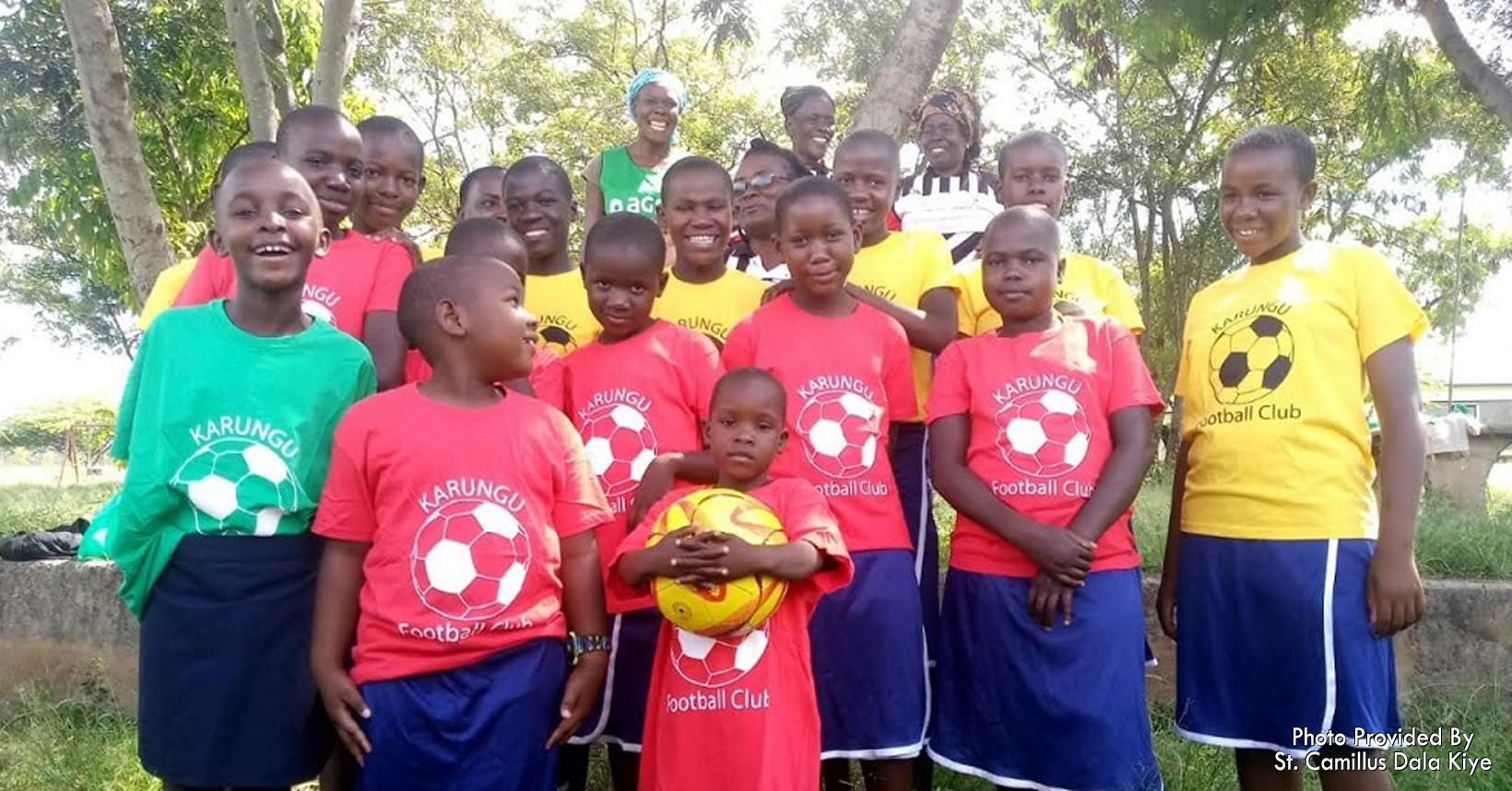 A group of children take a break from playing.