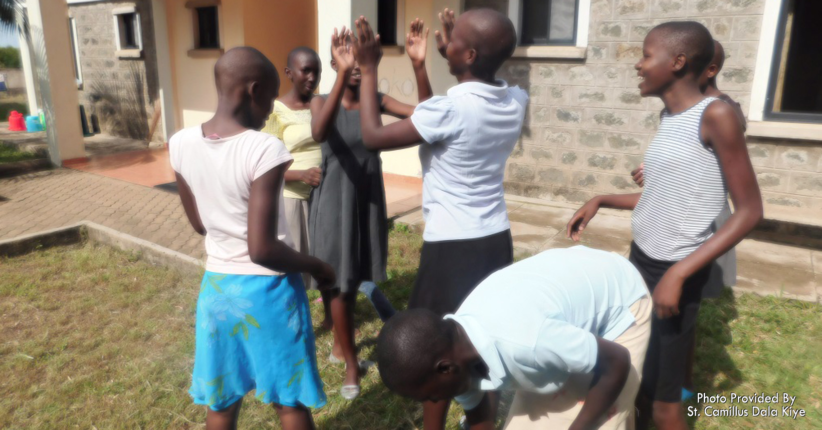 Girls play games outside of Tembo House.