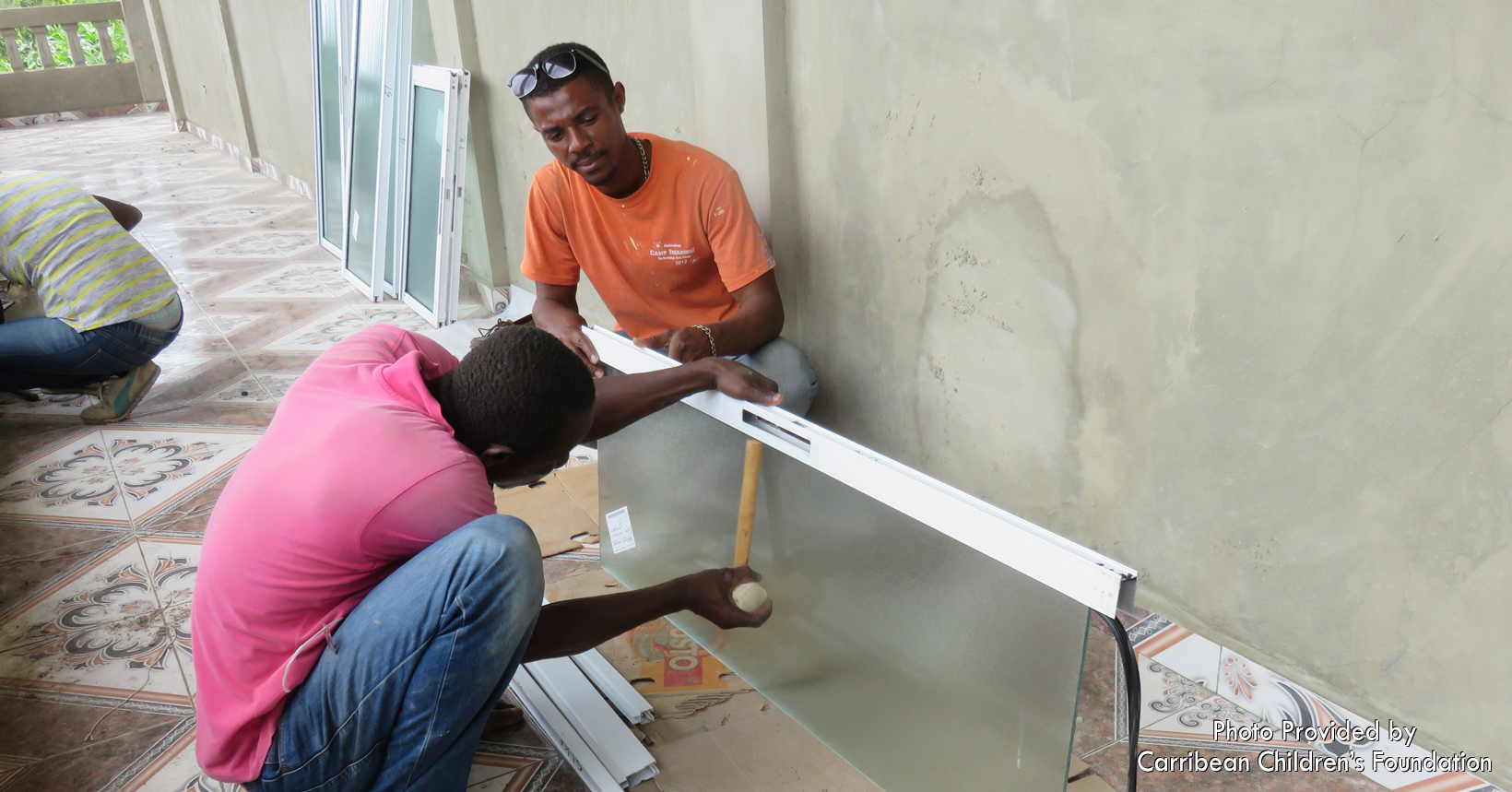 Windows were constructed on-site. The porch of the clinic, with its newly installed ceramic tiles, was the work place. A large percentage of the site workers are graduates of Grace Trade School - the first school on the island to teach trades to people who otherwise would only have work as farmers or fisherman, occupations that yield only about $.50 per day!