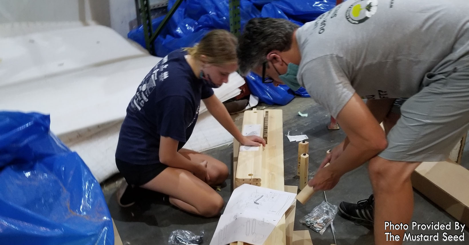 Volunteers from Advent Health are constructing the stackable beds.