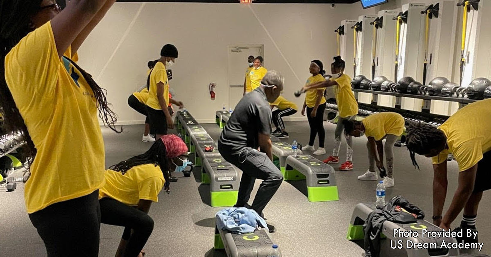 Students taking a step aerobics class.